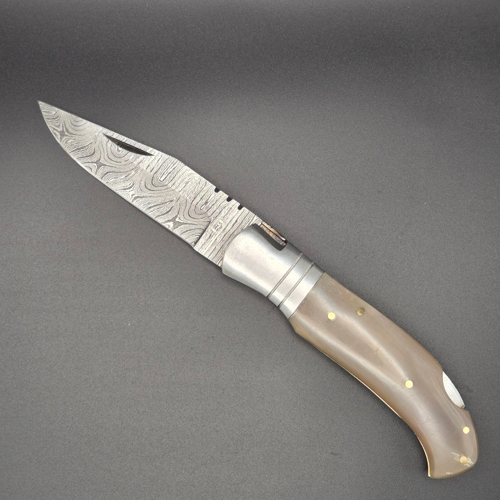 couteau utilitaire pliant avec lame Damas en position ouvert. Le manche est en os.