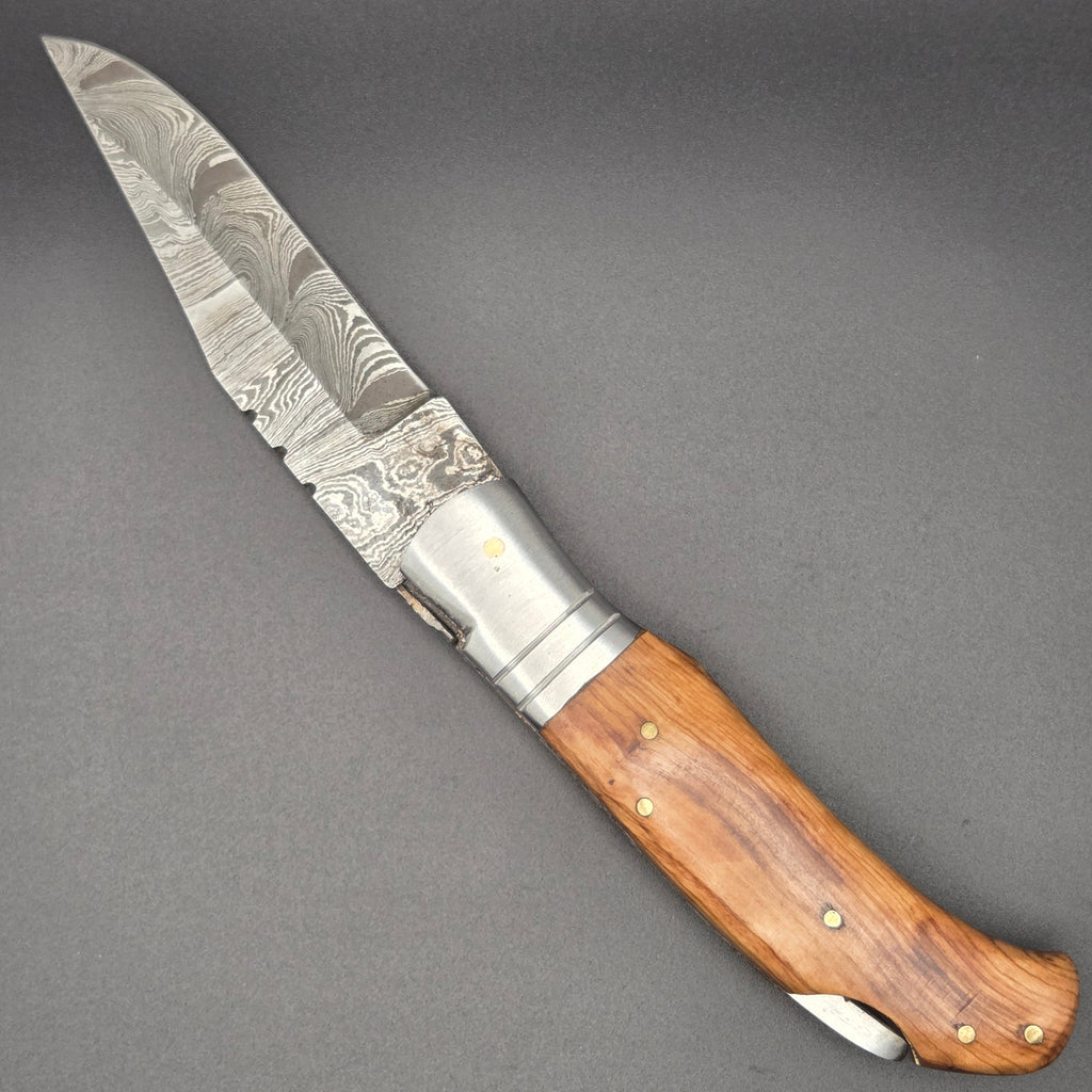 couteau pliant utilitaire en position ouvert avec lame damas et manche en teck